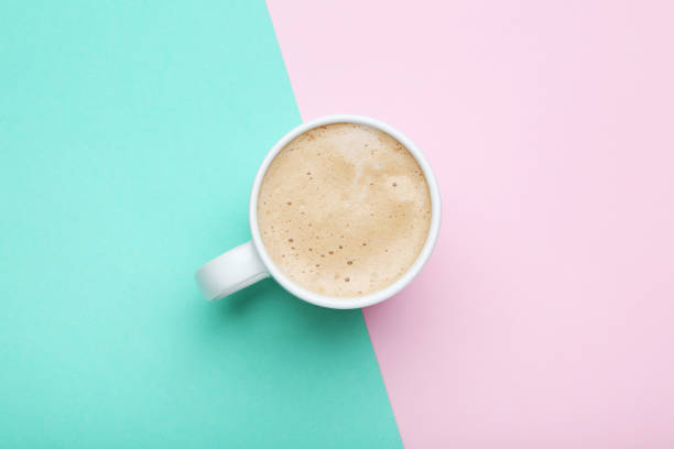 istock Cup of coffee on colorful background 1007768560
