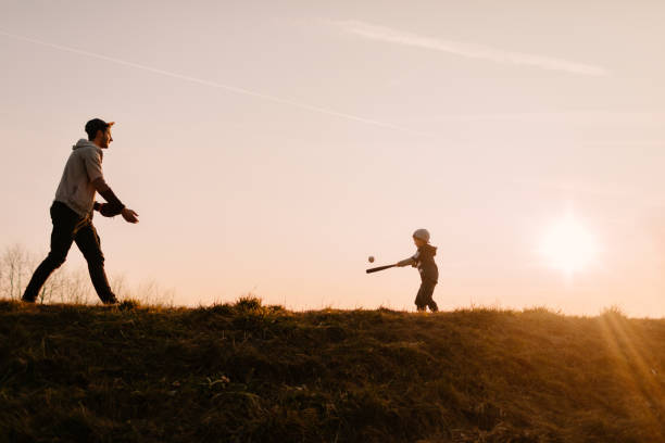 a game of softball on the field - playing catch imagens e fotografias de stock