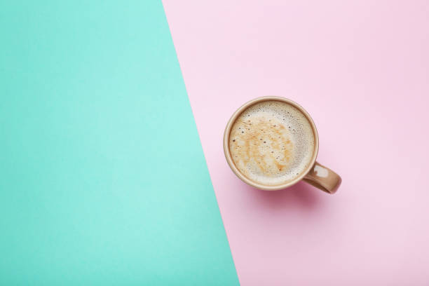 istock Cup of coffee on colorful background 1007769308