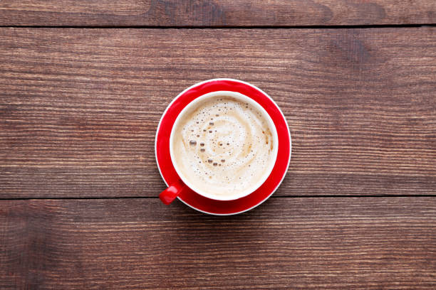 istock Cup of coffee on brown wooden table 1007776024