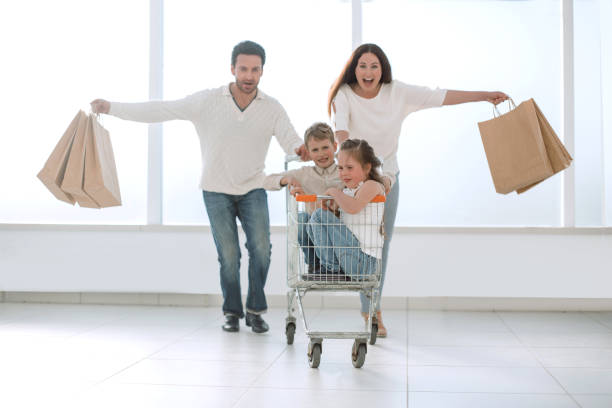 happy parents with children go shopping happy parents with children go shopping.shopping concep supermarket family retail cable car stock pictures, royalty-free photos & images