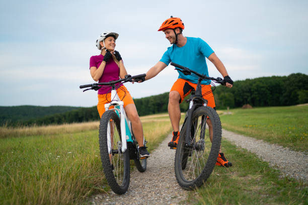 istock smiling couple on electric mountain bikes preparing for tour 1007782668