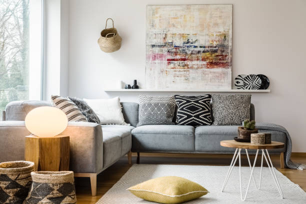 istock Yellow pillow and table on carpet in bright living room interior with light next to couch. Real photo 1007782826