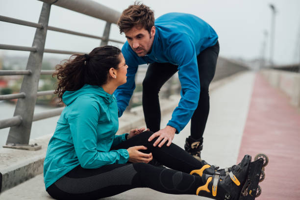 istock Young man looking at fit woman that fell down on the bridge 1007786964