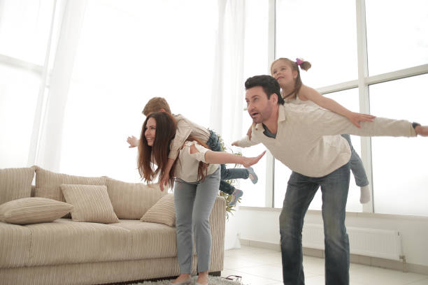 istock happy parents play with children at home 1007787138