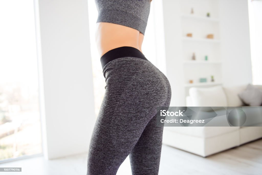 Weightloss wellness eating nutrition vitality concept. Cropped close up view photo of sexual sporty sportive tempting beautiful attractive nice round ass wearing gray tight pants leggings Buttocks Stock Photo