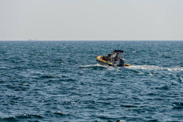 istock seascape with a motor boat on the horizon 1007790790