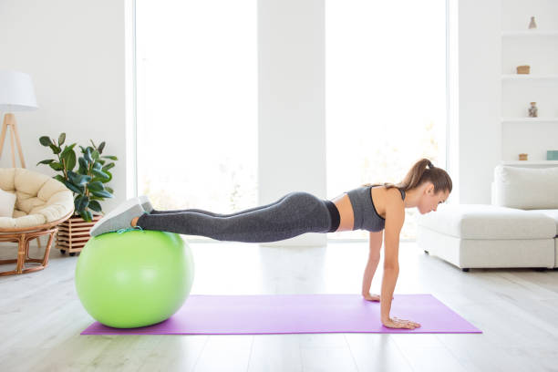 istock Activity club group person practicing balance abs energy abdomen pecs concept. Profile view photo portrait of attractive sexy sportive sporty beautiful lady in tracksuit standing on palms on floor 1007791072