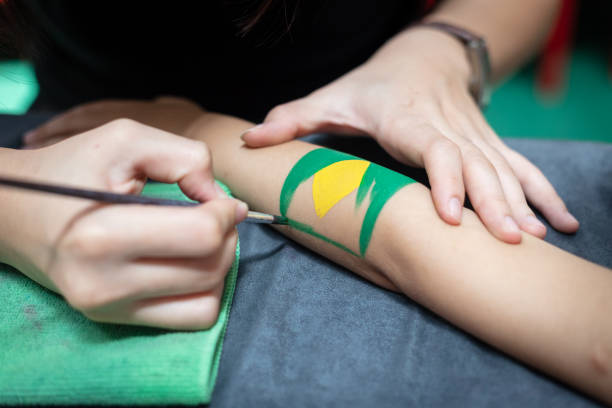 istock Children's arm painted a Brazil Flag 1007794114