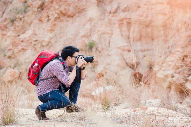 istock Young photographer travel red backpack enjoying a looking at Mountain abyss , Panoramic view. Traveling along , active lifestyle concept. 1007798618