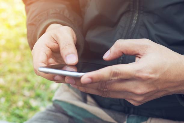 istock Mid section of military soldier using mobile phone in boot camp. letter from war. 1007798750