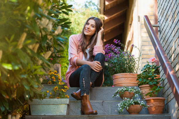 istock Relaxed young female smiling, sitting on home terrace. 1007807870