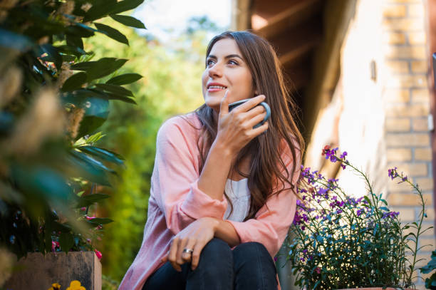 istock Girl drinking a hot beverage on home terrace. 1007808338