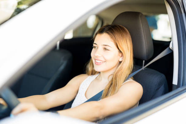 istock Attractive woman driving car 1007810784