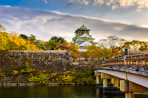 Osaka, Japan - November 24, 2012:  Osaka Castle at the moat and tower during the autumn foliage season.