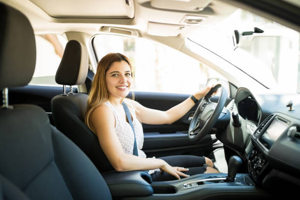 istock Pretty woman driving a car 1007814352