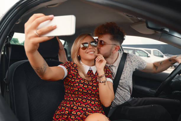 istock Happy Couple Taking Selfie In The Car 1007814738