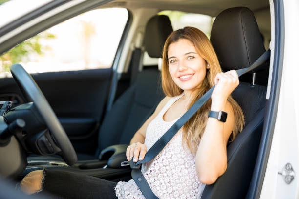 istock Woman putting her seat belt before driving 1007814976