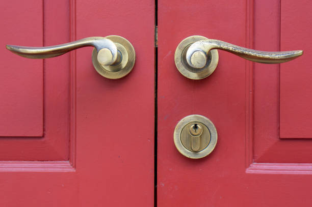 istock door handles on red wood door 1007817332