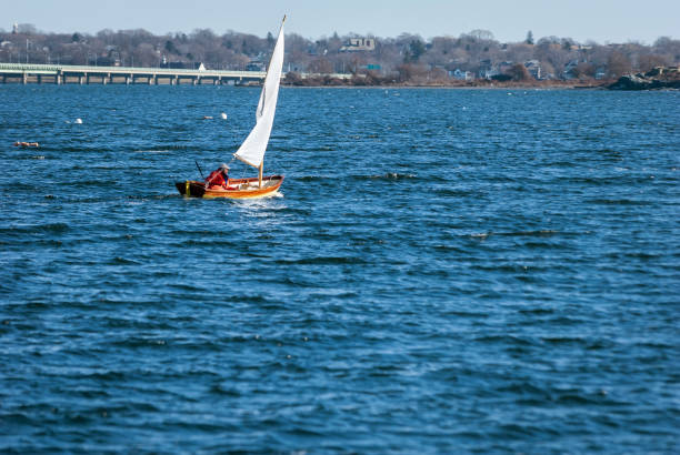 Jamestown, Rhode Island, USA - January 12, 2008: Sailor taking advantage of winter breeze off Jamestown