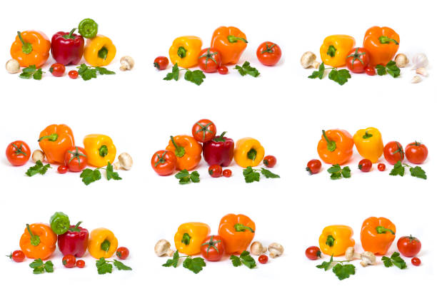 Red sweet pepper with a green tail on a black background. Dim lights. Close.