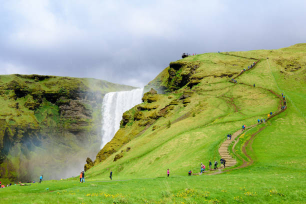 istock Grand waterfall Skogafoss in Iceland with people. 1007825416