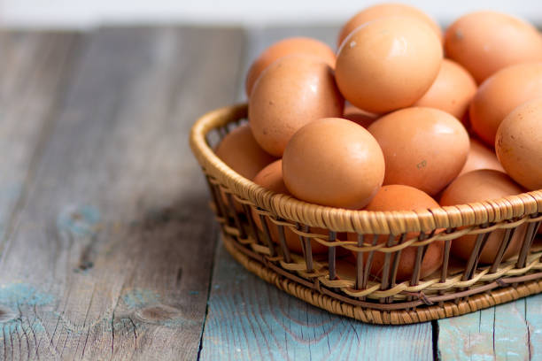 Brown farmers cage-free chicken eggs in basket, close up, rustic table Brown farmers cage-free chicken eggs in basket, close up cage photos stock pictures, royalty-free photos & images