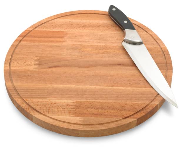 istock Wooden cutting board and knife isolated on white background 1007836444