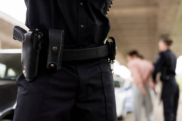 istock cropped image of policeman belt with gun and handcuffs 1007840326
