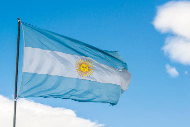 istock waving Flag from Argentina against blue sky 1007840756