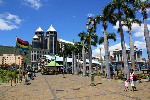 Port Louis, Mauritius, November 12th, 2009. The Caudan Waterfront is a shopping mall in the harbor of Port Louis. It is very popular, a lot of locals are visiting this area every day and strolling along the promenade.