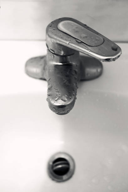 istock Faucet with water in the bathroom.Water drop. Slow Motion 120 fps. 1007840906
