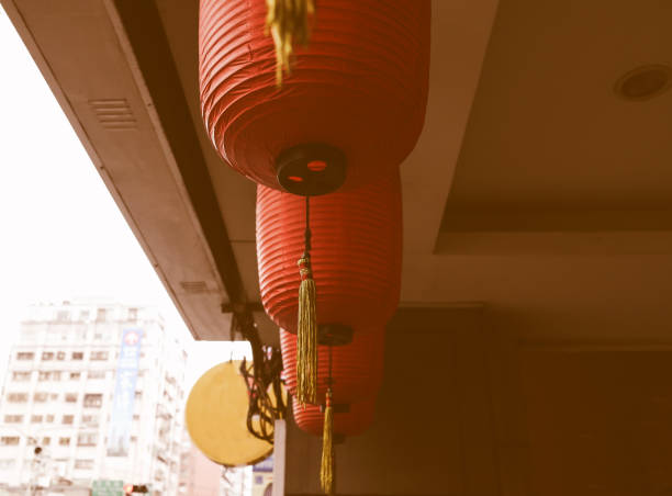 istock Ancient temples are hung with red lanterns, contrasting with modern architecture, 1007843978
