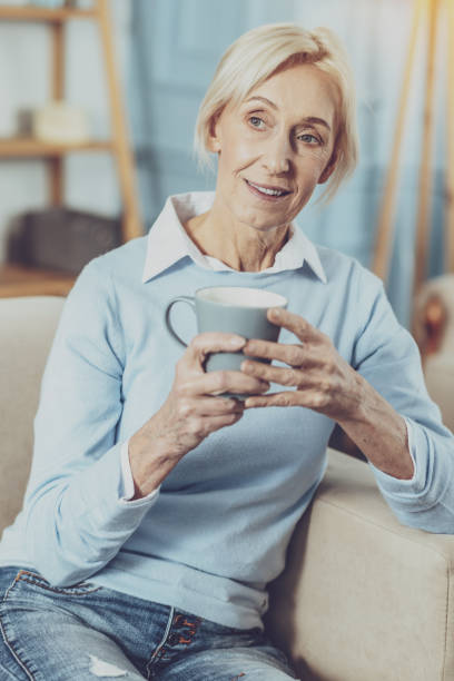 istock Pleased blonde woman being deep in thoughts 1007844876