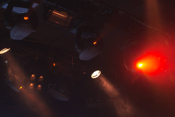 istock Red stage lights, strong spot beams in smoke 1007845088