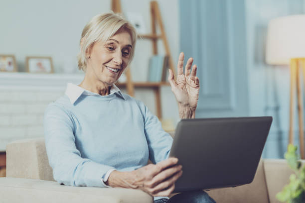 istock Happy mature woman communicating online 1007845764