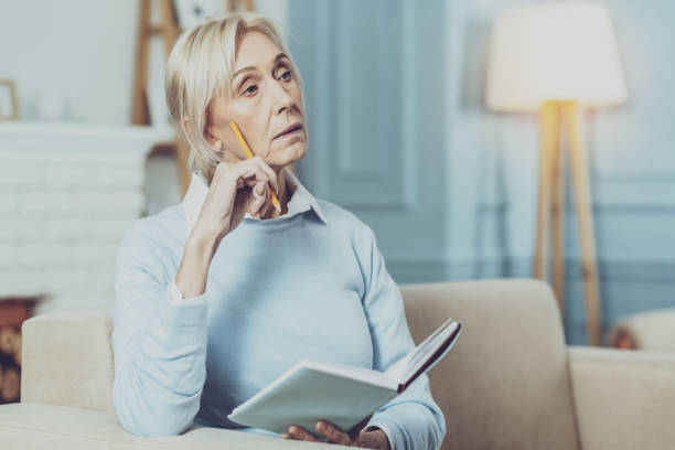 istock Attentive mature female being deep in thoughts 1007848836