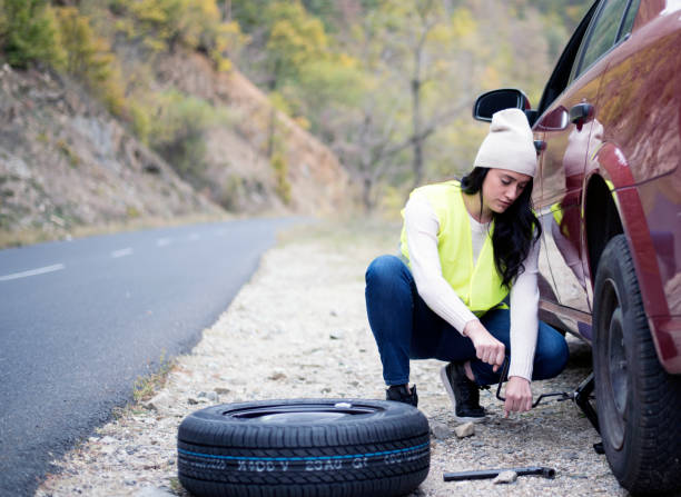 istock Young Women Changing A Flat Tire 1007850116