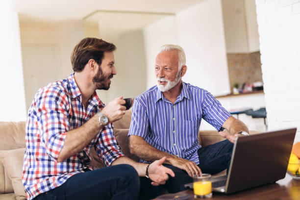 istock Adult Son Helping Senior Father With Computer At Home 1007853460