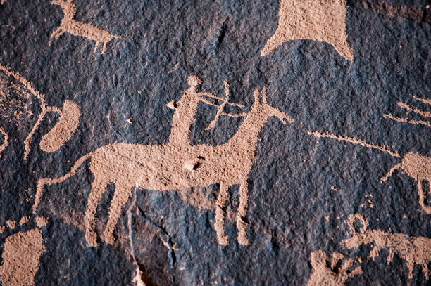 Native american hunter petroglyph Hunter petroglyph on Newspaper Rock in Canyonlands National Park, Southwest USA cave painting photos stock pictures, royalty-free photos & images