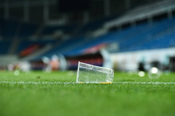 Plastic trash can on the turf on a soccer field stock photo