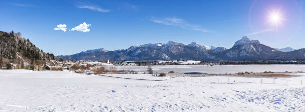 panoramic scene with lake Hopfensee and mountain range in region Allgäu in Bavaria panoramic scene with lake Hopfensee and mountain range in region Allgäu in Bavaria forggensee lake photos stock pictures, royalty-free photos & images