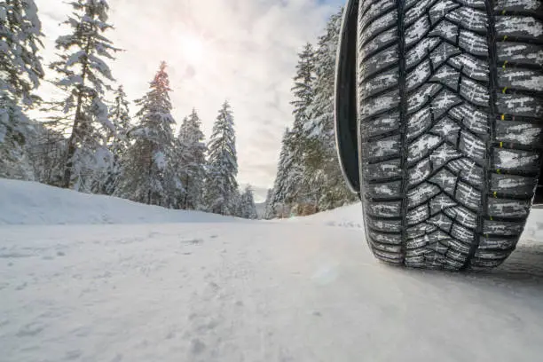 Photo of car with winter tires on snowy road