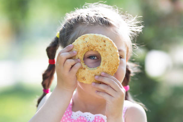 istock A child is playing with bread in the sun. 1007858518