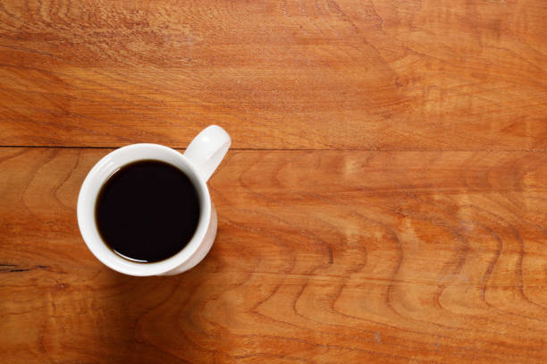 istock Cup of Coffee on Wood Table 1007862812