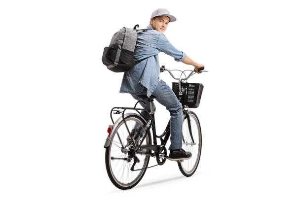 istock Teenager with a backpack riding a bicycle 1007869042