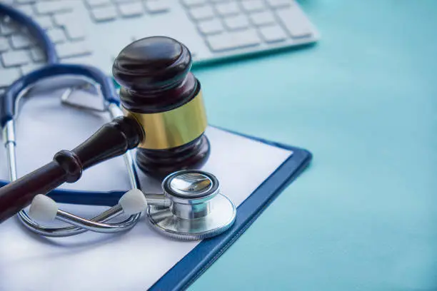 Gavel and stethoscope. medical jurisprudence. legal definition of medical malpractice. attorney. common errors doctors, nurses and hospitals make