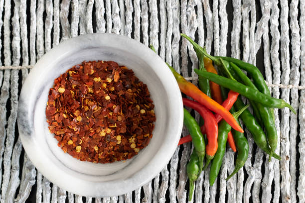 istock Spicy Crushed Red Pepper and Fresh Cayenne Peppers 1007916020