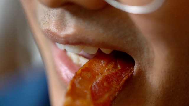 SLO MO - CU Eating Bacon