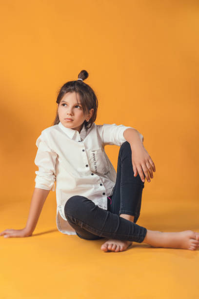 istock child in the Studio posing in fashionable clothes 1007919186